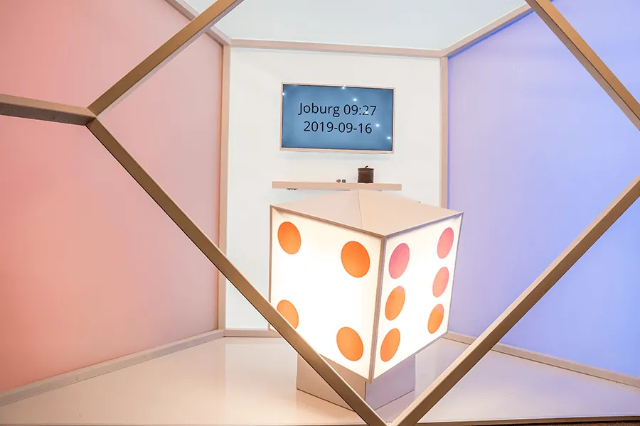 Dice Duel: BetGames' photo of the empty Dice Duel studio, seen through a pale wooden...