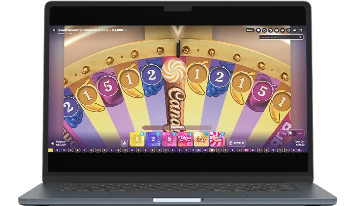 Sweet Bonanza CandyLand: Pragmatic's image of the game on a laptop: the top of the wheel, the pointer...